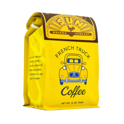 A bright yellow bag of French Truck Coffee from Sun Record Company, featuring a retro illustration of a yellow truck and black text, set against a plain white background.
